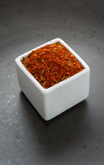 Oriental herbs spice mix on dark ceramic dish
