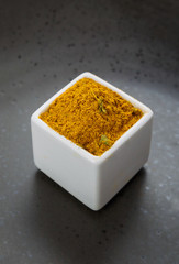 Oriental herbs spice mix on dark ceramic dish