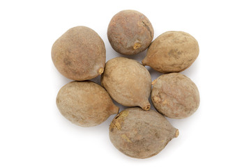 Organic dry Bahera or Beleric (Terminalia bellirica) seeds. Isolated on white background. Macro close up. Top view.