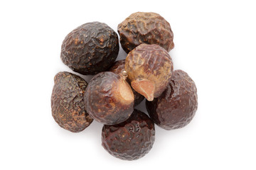 Organic Chinese soapberry or Reetha (Sapindus mukorossi) seeds. Isolated on white background. Macro close up. Top view.