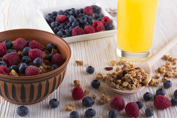 Muesli with fresh berries and orange juice.