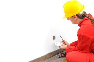 Close up of woman electrician fixing socket