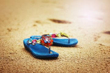 Fototapeta na wymiar Beach flip flops on tropical sandy coast