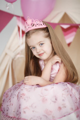 Obraz na płótnie Canvas cute smiling little girl in pink princess