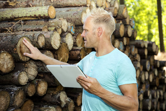 Man in the woods with Tablet PC