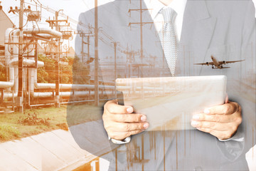  Double exposure of success businessman using digital tablet with airplane flying over industrial estate land use for heavy logistics or  import export for Oil refinery industry