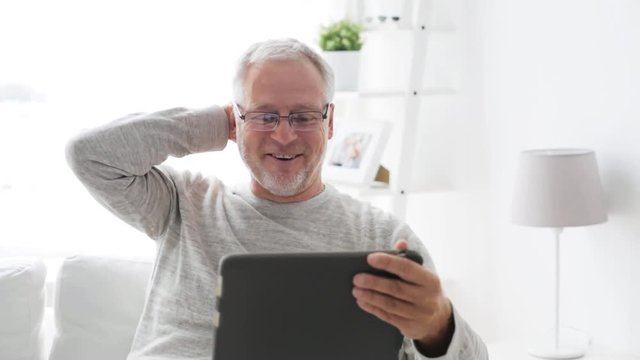 senior man having video call on tablet pc at home 12