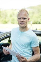 Man with Tablet PC and automotive