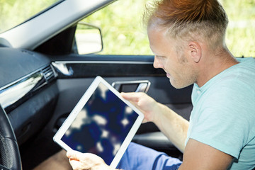 Man with Tablet PC and automotive