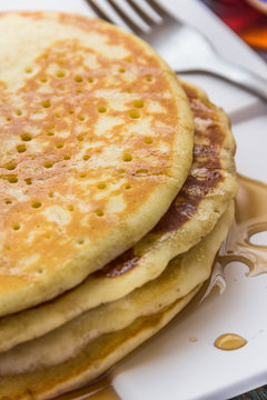 Pancake with honey vertical close up image.
