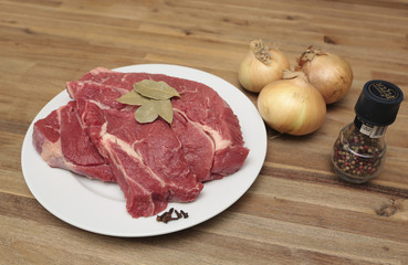 Beef on a plate with a few onions and spices