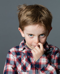 little boy scratching nose for reflection, stress, cold or allergies