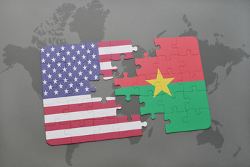 puzzle with the national flag of united states of america and burkina faso on a world map background.