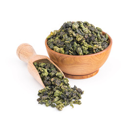 Tieguanyin oolong green tea in a wooden bowl isolated on white