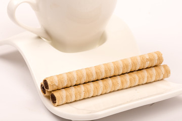 Wafer chocolate cream rolls on the coffee plate