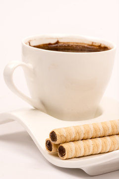 Wafer chocolate cream rolls on the coffee plate