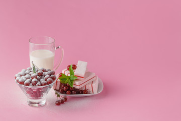 Glass of milk and wild cherry with sugar powder