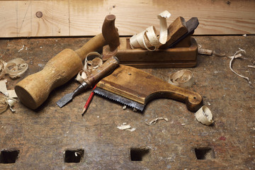Carpenter tools with wood shaving on wooden table