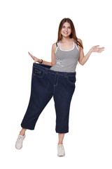 Obraz premium Young woman happy of weight loss diet results, isolated