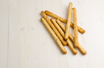 rustic breadsticks on wood table, close up, background.