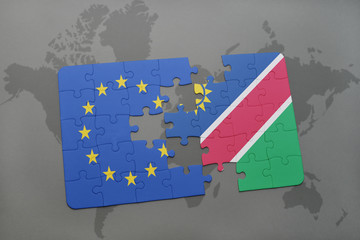 puzzle with the national flag of european union and namibia on a world map background.