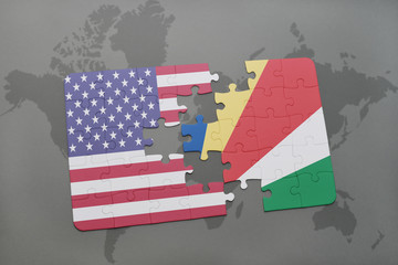 Obraz premium puzzle with the national flag of united states of america and seychelles on a world map background.