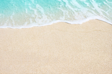 Naklejka na ściany i meble Soft wave of sea on the sandy beach, background