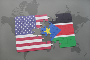 puzzle with the national flag of united states of america and south sudan on a world map background.