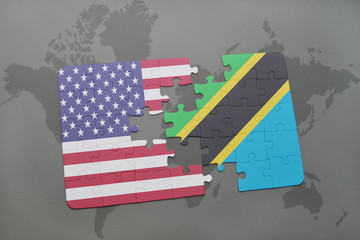 puzzle with the national flag of united states of america and tanzania on a world map background.