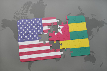 puzzle with the national flag of united states of america and togo on a world map background.
