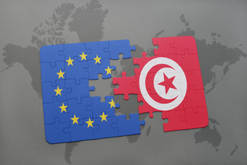 puzzle with the national flag of european union and tunisia on a world map background.