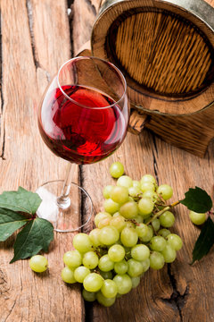 Wine and cheese on wooden table with fresh grapes 