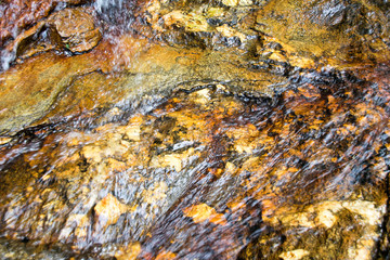 Close up Water flowing on the rocks for nature texture background