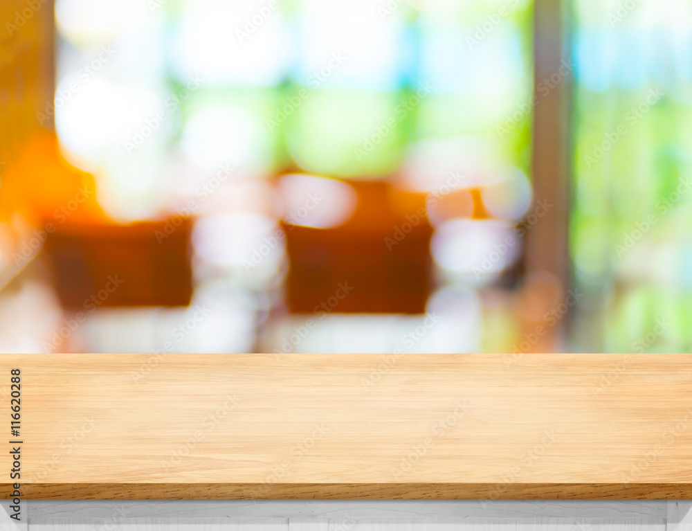 Aufkleber Empty wooden table top with blurred cafe bokeh light as backgrou