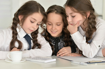 Three little girls making homework