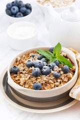 berry crumble with oatmeal in a ceramic form on white table