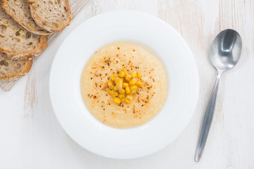 delicious corn soup and bread, top view, closeup
