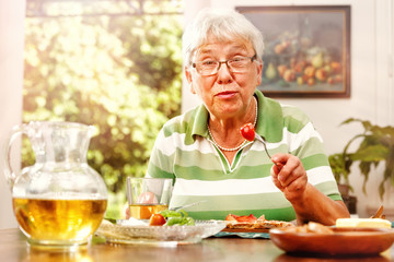 Elderly Lady has a Meal at Home