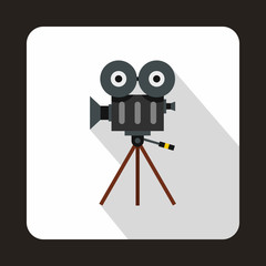 Retro cinema camera icon in flat style on a white background