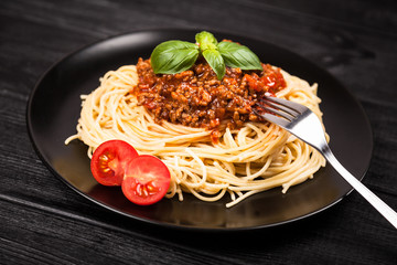 Spaghetti bolognese on dark background