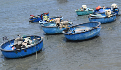 Fototapeta na wymiar traditional basket boat and ship in fishing village, muine, vietnam