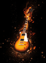 Burning wooden guitar with orange flames