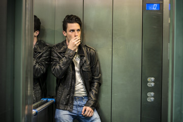 Scared young man desperate in stuck elevator screaming, looking very upset © theartofphoto