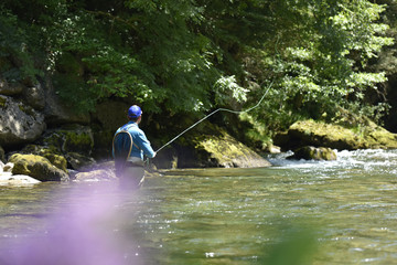 Flyfisherman fishing in mountain river
