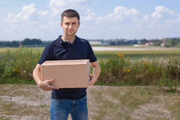 Young man holding in his hand a package.