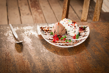 Ice cream in dish on wooden table