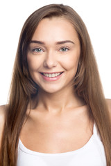 Portrait of happy beautiful attractive Caucasian young woman with long hair posing against white background. Front view of smiling cheerful girl wearing casual closing. Studio vertical image. Close-up