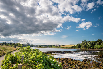 Weir on River Coquet below Warkworth, with its castle on the skyline