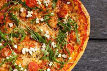 Pizza with cheese, letuce, tomatoes and cheese freshly baked on