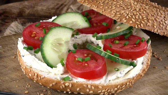 Bagels with Cream Cheese and vegetables (rotating, close-up) as not loopable 4K UHD footage